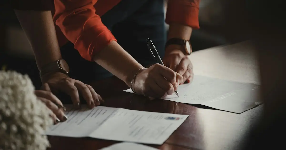 Hands writing notes on paper