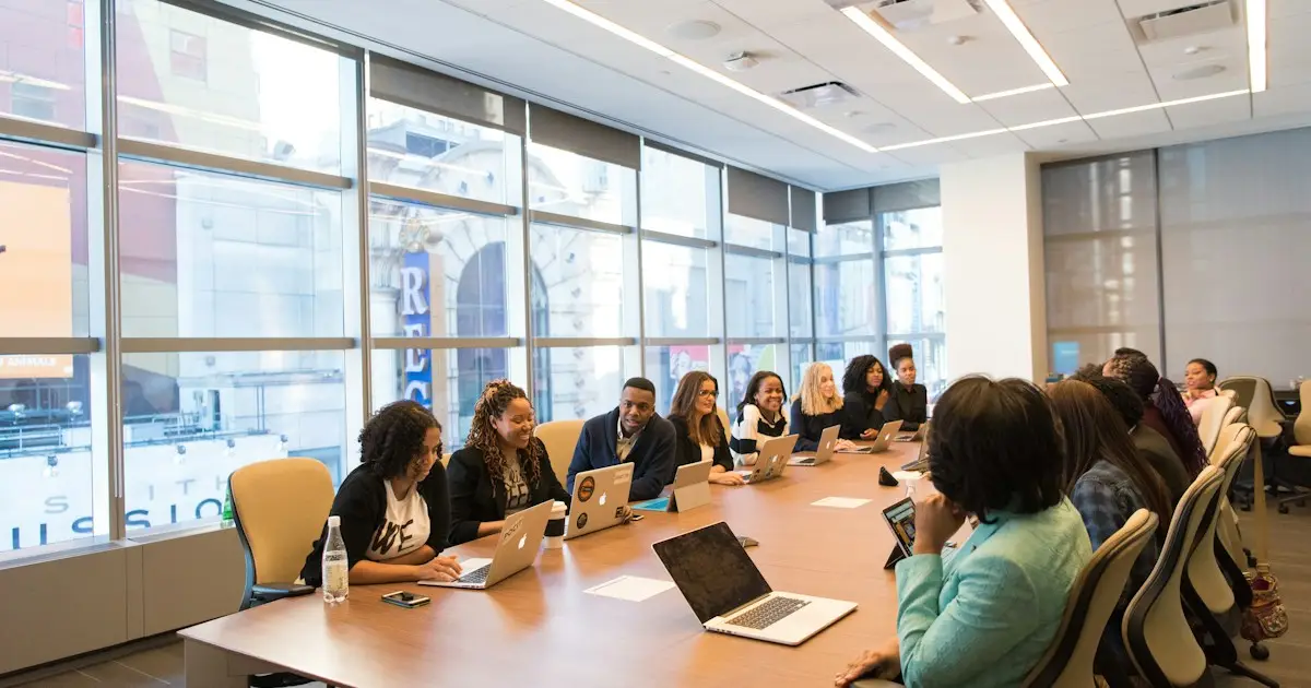 Business team meeting around a table with laptops