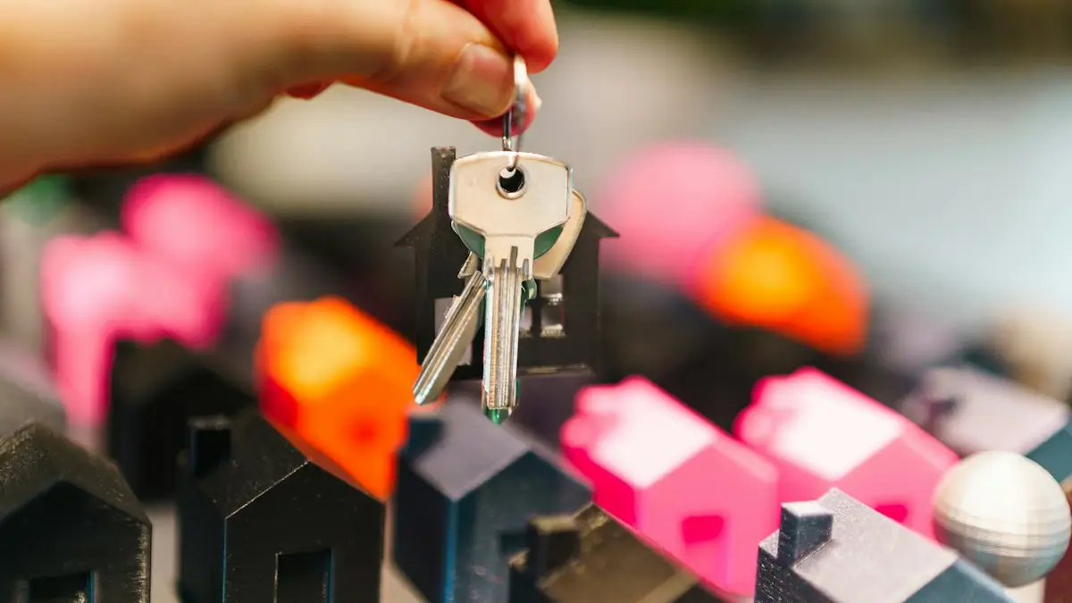 House keys held above miniature model homes